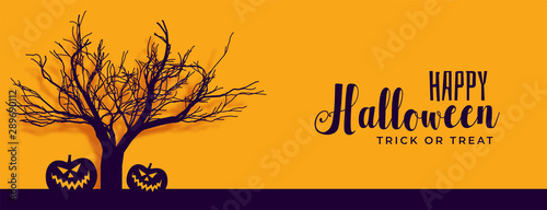happy halloween banner with scary tree and pumpkin