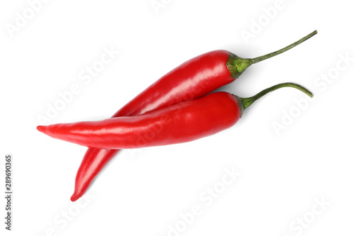 Ripe red hot chili peppers on white background, top view