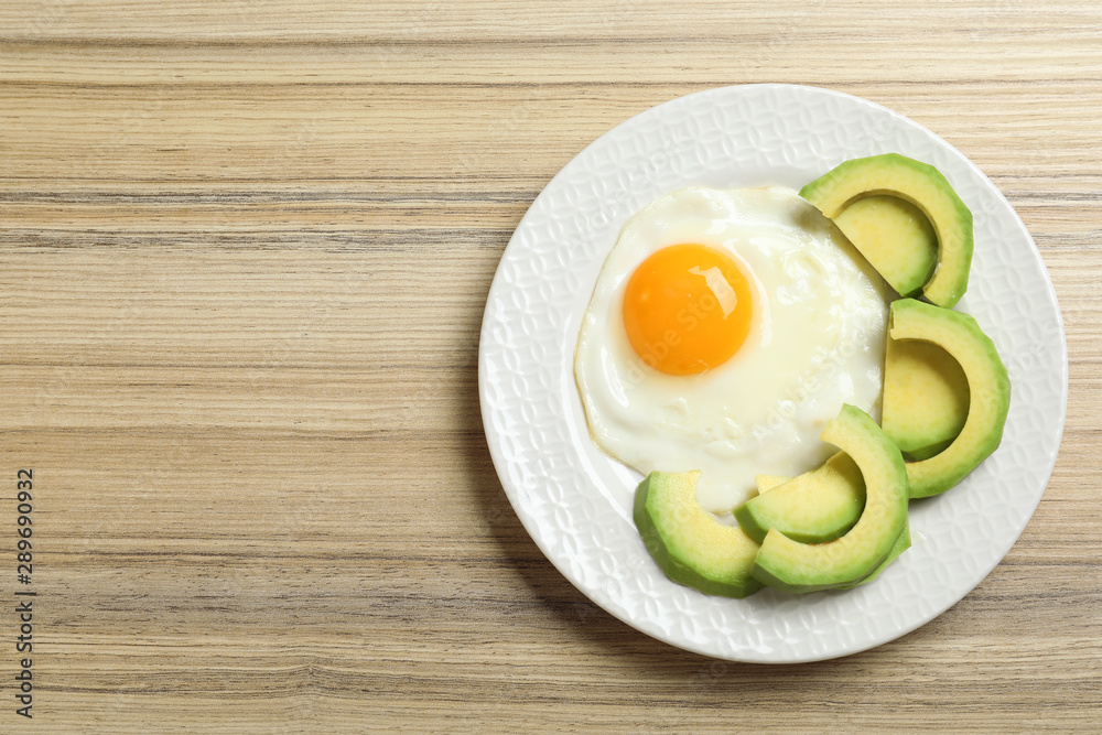 Delicious breakfast with fried egg served on wooden table, top view. Space for text Delicious breakfast with fried egg served on wooden table, top view. Space for text