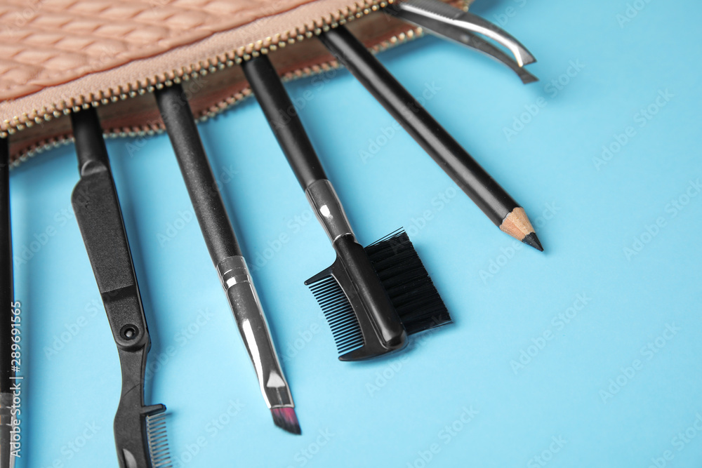 Set of professional eyebrow tools on blue background Set of professional eyebrow tools on blue background