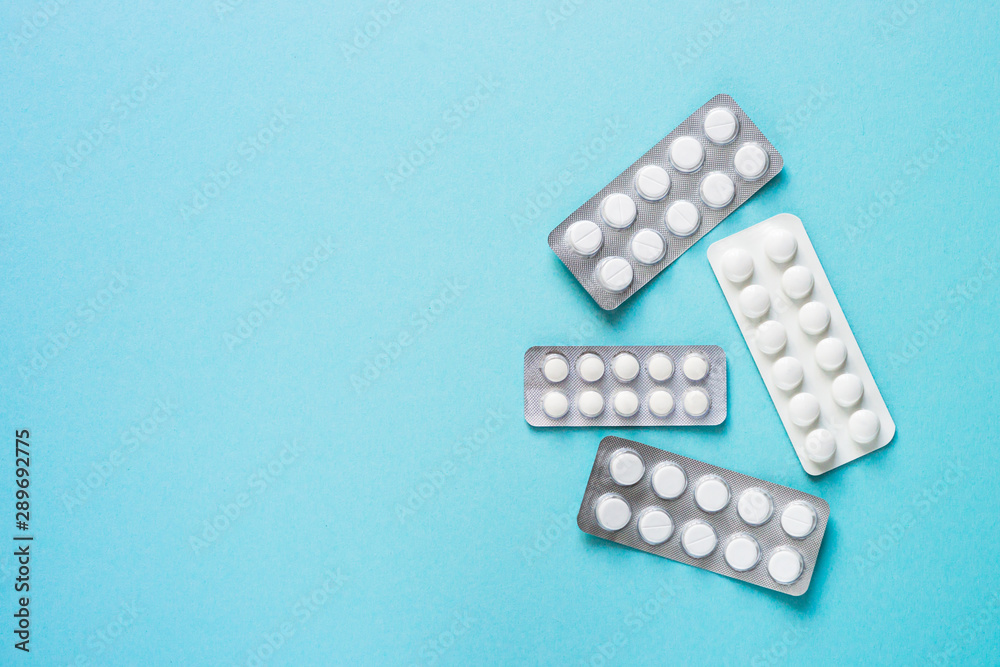 Pills on blue background top view. Pills on blue background top view.