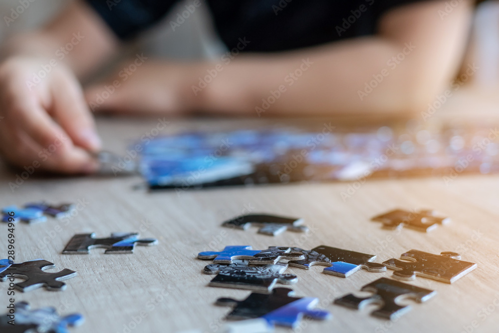 boy raises a small puzzle. childhood development boy raises a small puzzle. childhood development