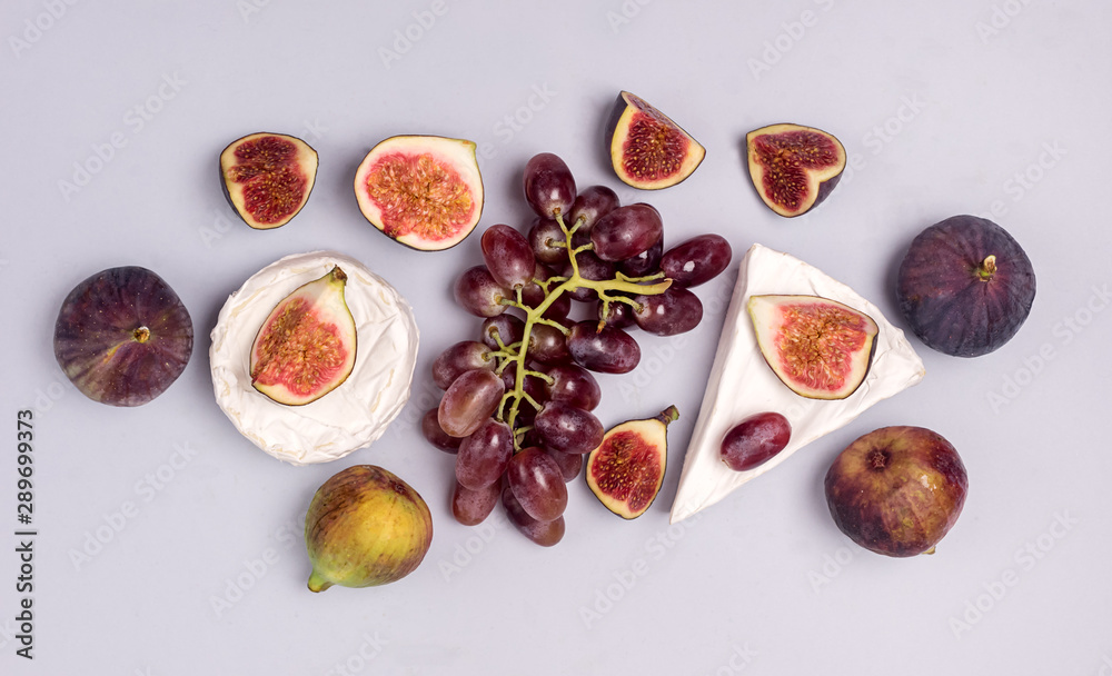 Brie Cheese Ripe Cut Figs Ripe Grape are Lying on Blue Background Food Background with Cheese and AutumnFruits Copy Space Horizontal Flat Lay Brie Cheese Ripe Cut Figs Ripe Grape are Lying on Blue Background Food Background with Cheese and AutumnFruits Copy Space Horizontal Flat Lay
