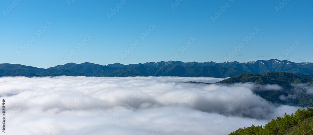 Panorama view from Unkai Terrace in summer time sunny day. Take the cable car at Tomamu Hoshino Resorts, going up to see the sea of clouds. Shimukappu village, Hokkaido, Japan Panorama view from Unkai Terrace in summer time sunny day. Take the cable car at Tomamu Hoshino Resorts, going up to see the sea of clouds. Shimukappu village, Hokkaido, Japan