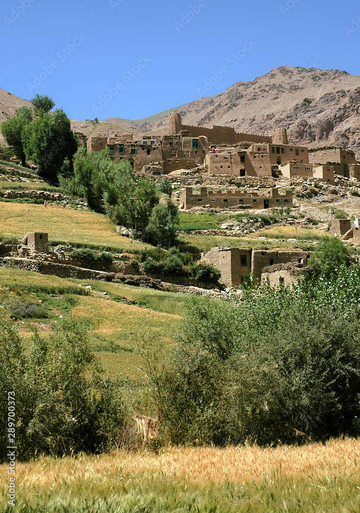 Village with local Afghan houses and a fort. Scenery between Kabul and Bamyan (Bamiyan), Afghanistan. Taken from the road on the southern route between Kabul and Bamyan (Bamiyan), central Afghanistan.
