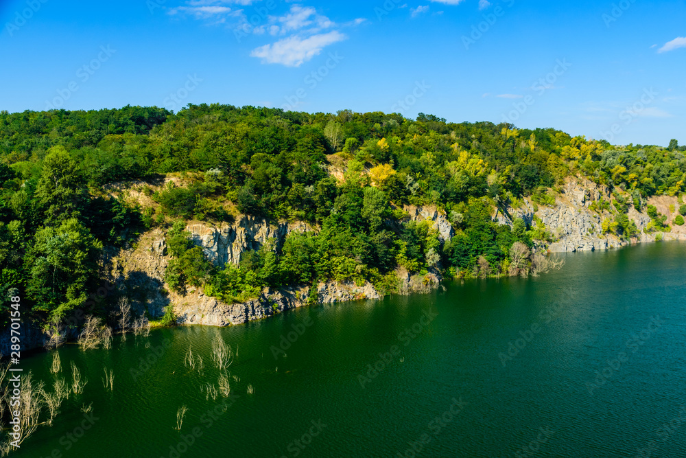 Beautiful lake in the abandoned granite quarry on summer