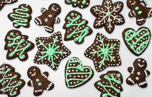 Gingerbread cookies on white background. Snowflake, star, man, heart shapes.