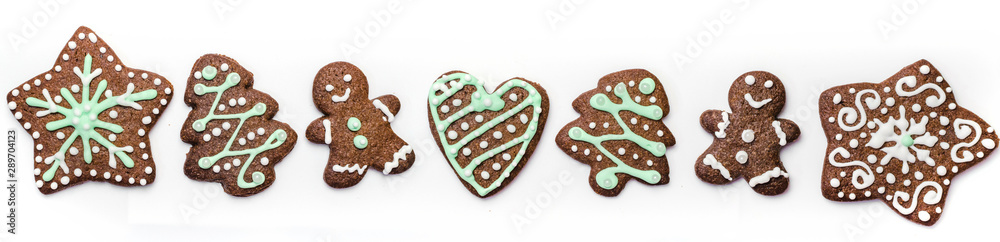 Gingerbread cookies on white background. Snowflake, star, man, heart shapes. Gingerbread cookies on white background. Snowflake, star, man, heart shapes.