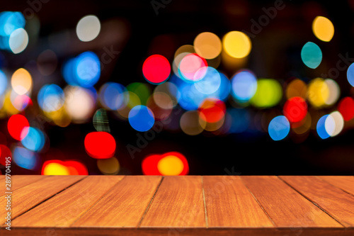 Wood table top on traffic bokeh light background