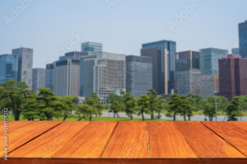 Wood table top on park and city background. For display and montage products