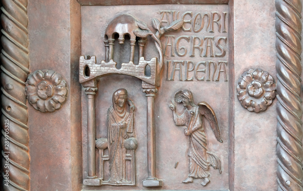 Annunciation of the Virgin Mary on the San Ranieri gate of the Cathedral St. Mary of the Assumption in Pisa, Italy 