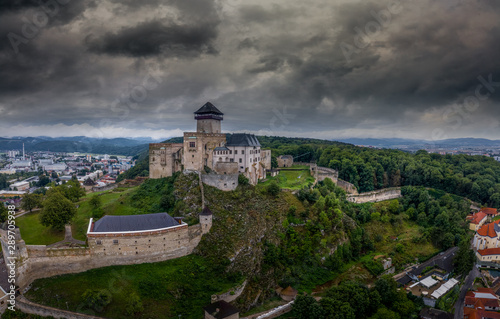 Aerial panorama view of medieval newly restored Trencin castle over the Vah river in Slovakia with dramatic sky