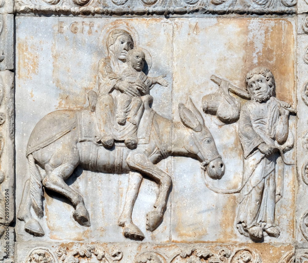 Flight to Egypt, medieval relief on the facade of Basilica of San Zeno in Verona, Italy