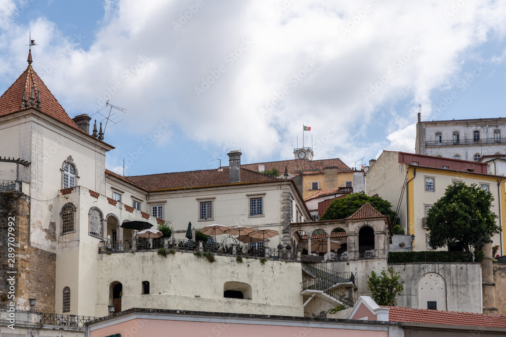 Restaurant with balcony below University of Coimbra on hilltop above the city from Santa Clara bridge