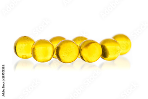 yellow round small capsules with medicine on a black background