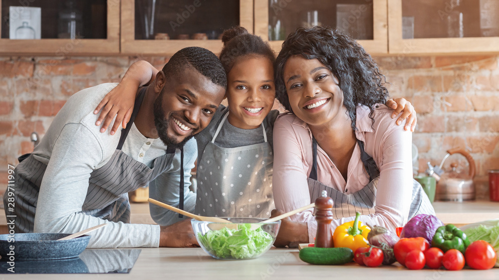Cheerful african family having good time while cooking