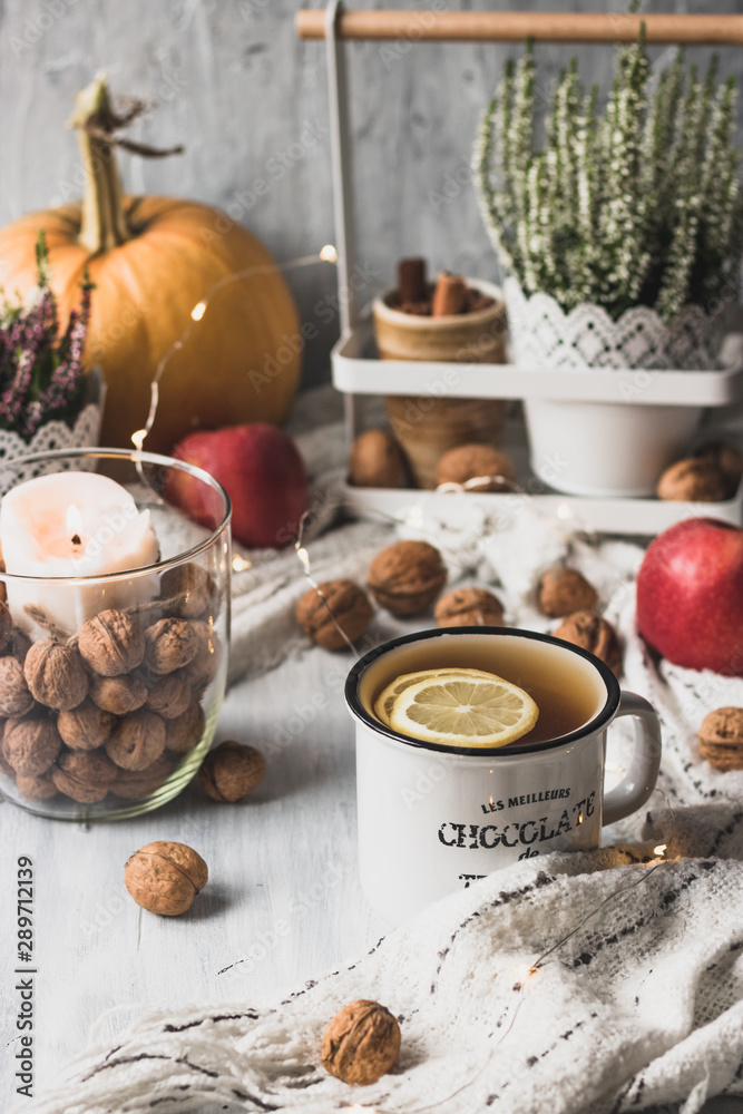 Fototapeta premium autumn cosy pumpkin, candles and autumn plants on window with led lights bokeh
