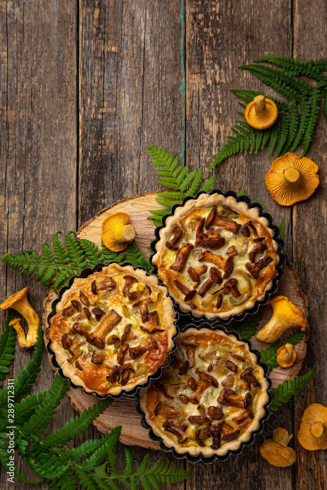 chanterelle mushrooms tarts or quiches on wooden background