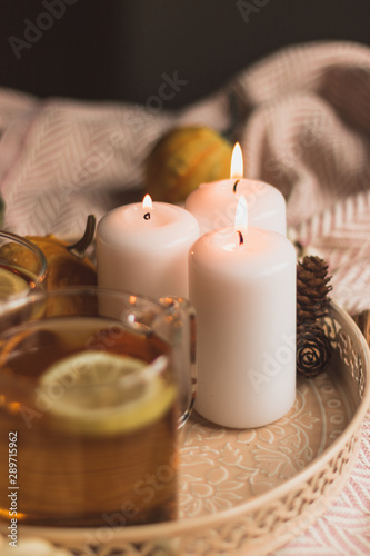autumn cosy pumpkin  candles and autumn plants on window with led lights bokeh