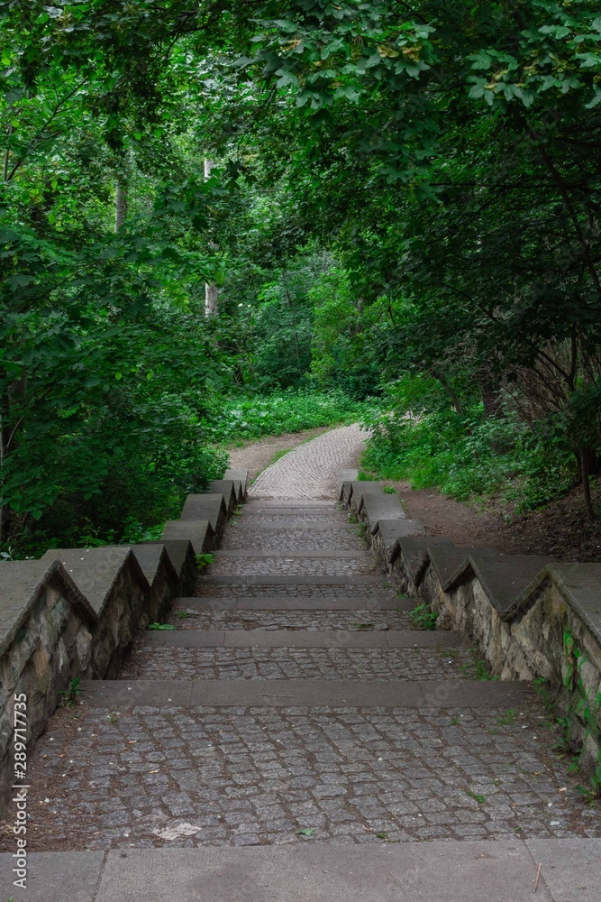 Walk on a warm sunny day in the park Volkspark Friedrichshain in Berlin, stone stairs