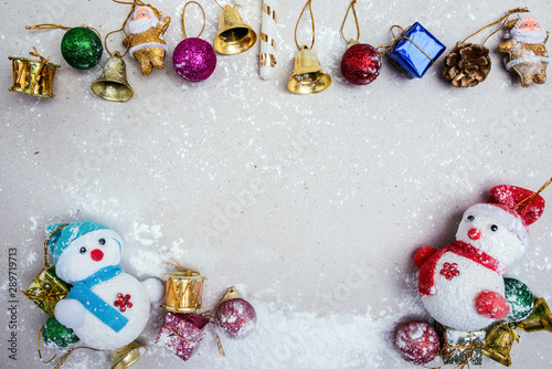 Happy Christmas composition. Gifts, Bell,Ball on top,Snowman and snow on white background. Christmas, winter, Christmas holiday concept. top view, copy space.