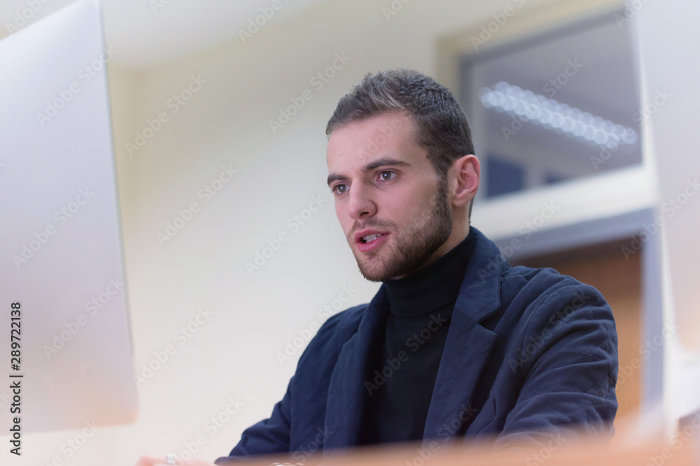 Fototapeta premium Programming. Man Working On Computer In IT Office, Sitting At Desk Writing Codes. Programmer Typing Data Code, Working On Project In Software Development Company. High Quality Image.
