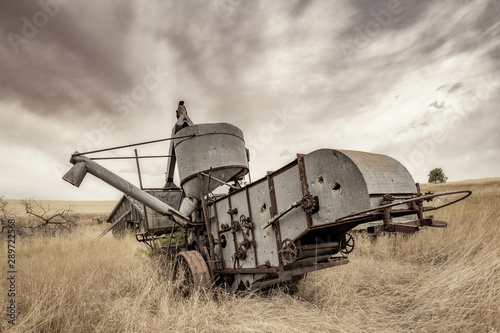 Antique combine left if a field to rot in Norther Idaho farm country