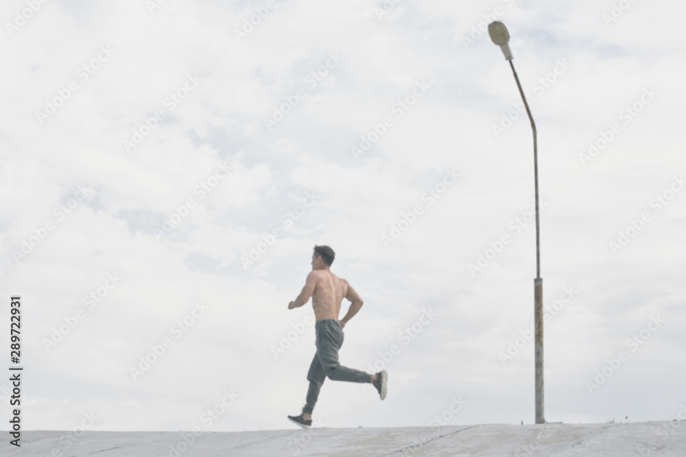 Asian athlete man jogging in the morning outdoors, Kazakh runner minimalism photo style Asian athlete man jogging in the morning outdoors, Kazakh runner minimalism photo style