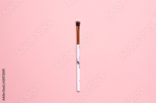 Beauty make up brushes on a pink background