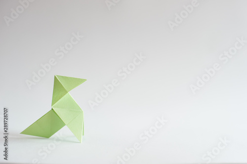 Photograph of a colored paper bow tie in front of a white background. Space for text. Background. For presentations