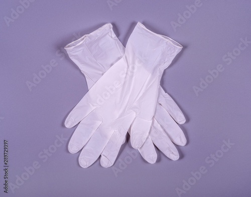 A pair of white medical gloves on a gray background © RusGri