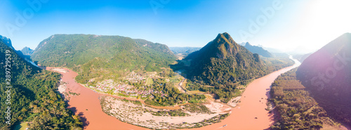 Aerial panoramic Nam Ou River Nong Khiaw Muang Ngoi Laos, dramatic landscape scenic pinnacle cliff mountain range famous travel destination in South East Asia
