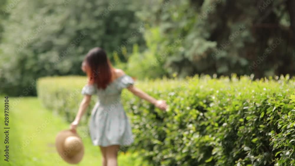 Sunny photo shoot in the alley. girl in a hat walking in the summer Park. Sunny photo shoot in the alley. girl in a hat walking in the summer Park.