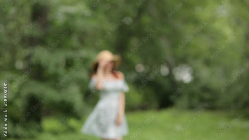 Sunny photo shoot on. Girl in a hat walking in the summer Park. Sunny photo shoot on. Girl in a hat walking in the summer Park.