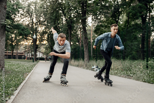 Roller skating, two male skaters begins speed race