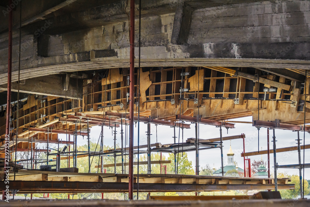 Wooden formwork with scaffolding for the construction of a bridge.