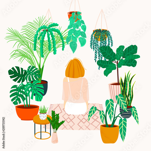 Girl caring for plants. Greenhouse, plants growing in pots.