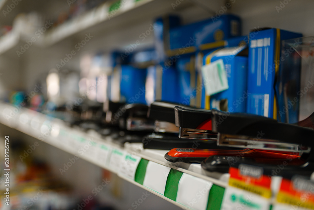 Shelf with staplers in stationery store, nobody Shelf with staplers in stationery store, nobody