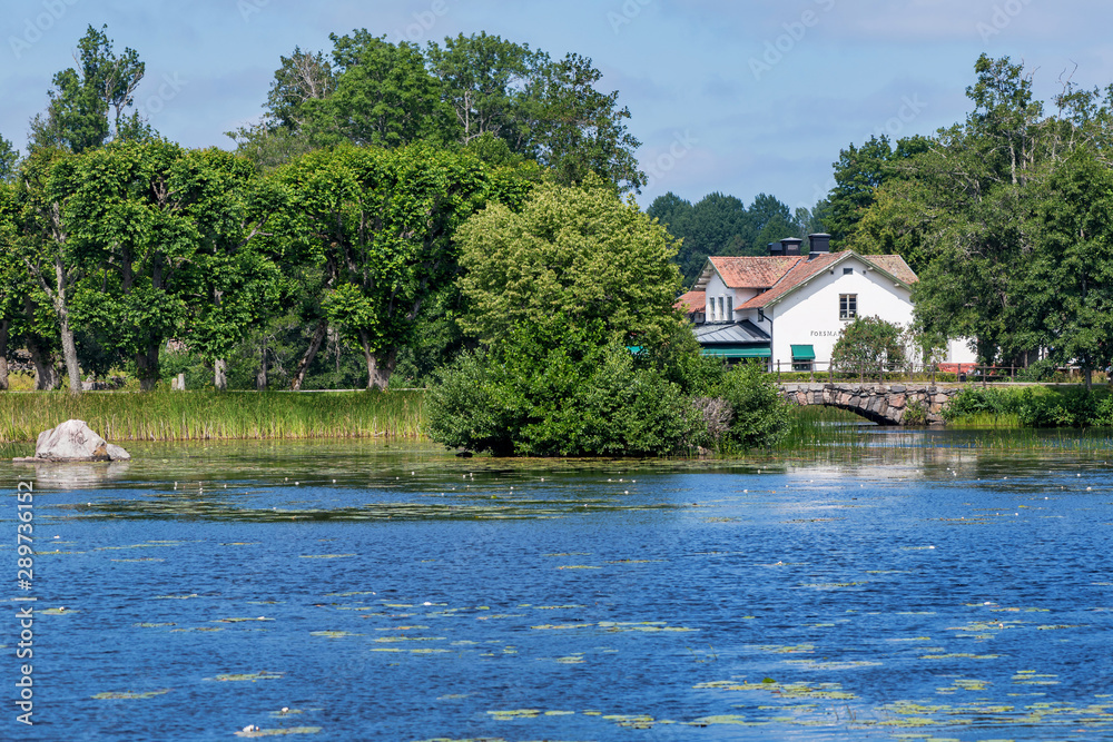 Iron work area with its old white buildings reflected in the pond