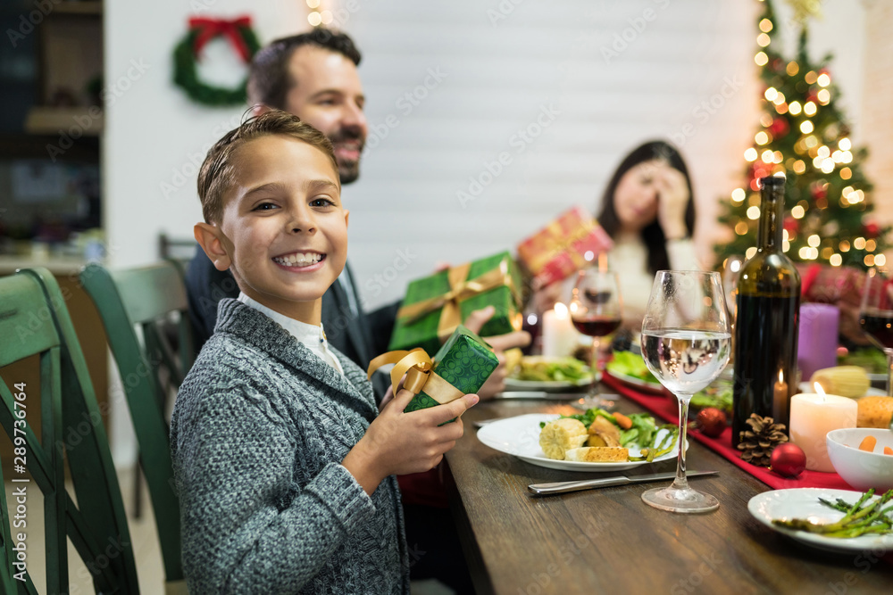Excited Kid With Christmas Present At Dinner Party In House