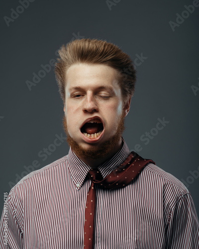 Billede på lærred Strong wind blowing in male face, funny emotion