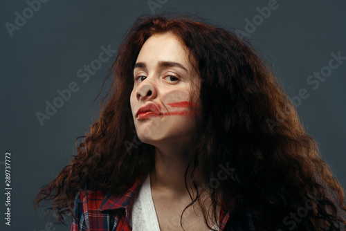 Woman's face crushed on glass, smeared lipstick photo