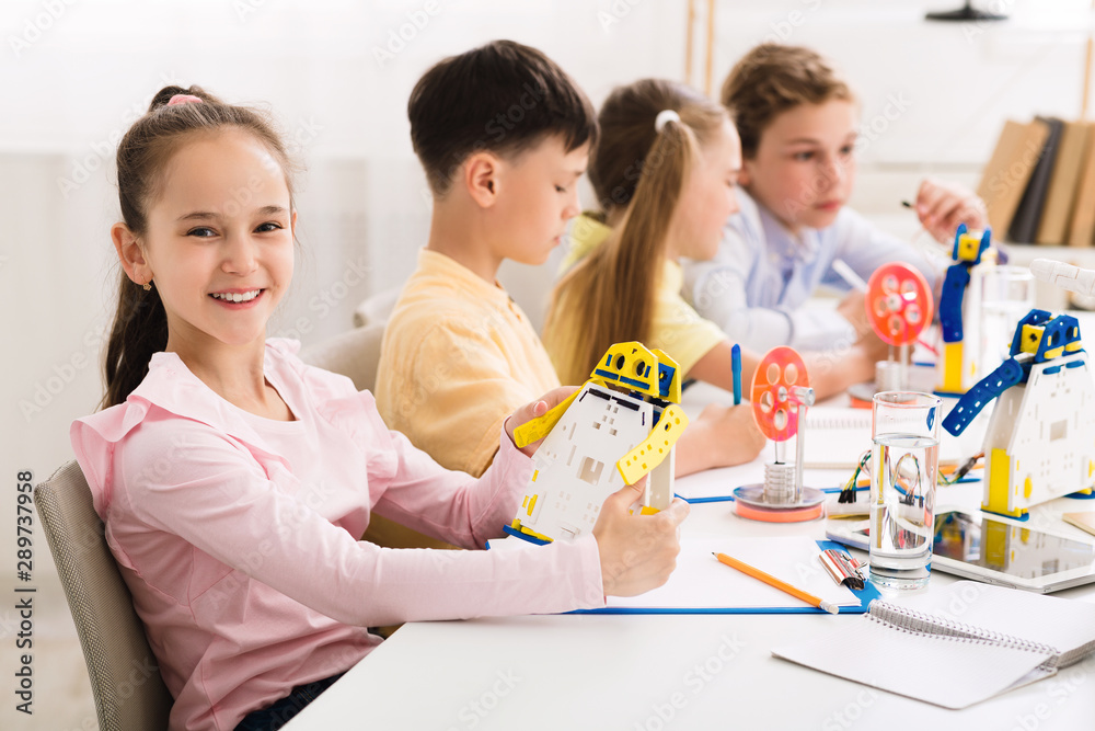 Stem education. Girl creating robot at lab Stem education. Girl creating robot at lab