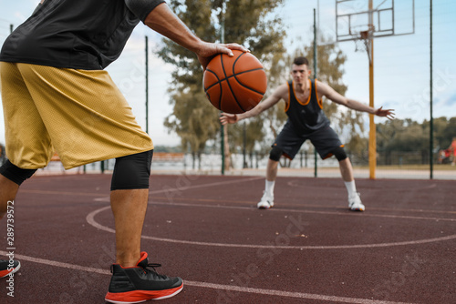 Two basketball players work out tactics outdoor