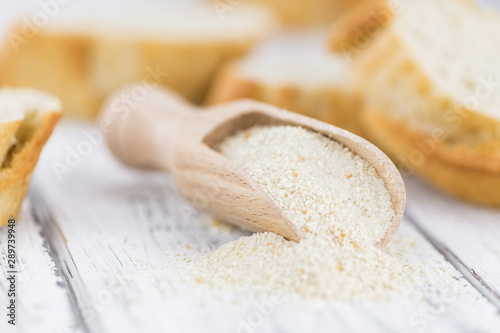 Photos Some fresh Bread Crumbs on wooden background (selective focus; close-up shot)