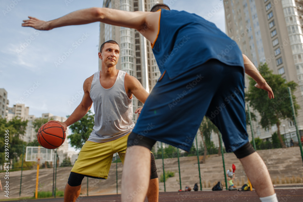 Two players in the center of basketball field