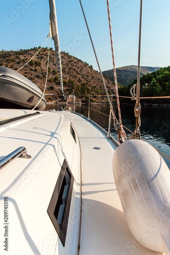 Boat in a quiet bay of Smrka on Brac island, Croatia. Morning in Croatian bay. Holiday on a yacht. Yachting sport. Yacht deck.