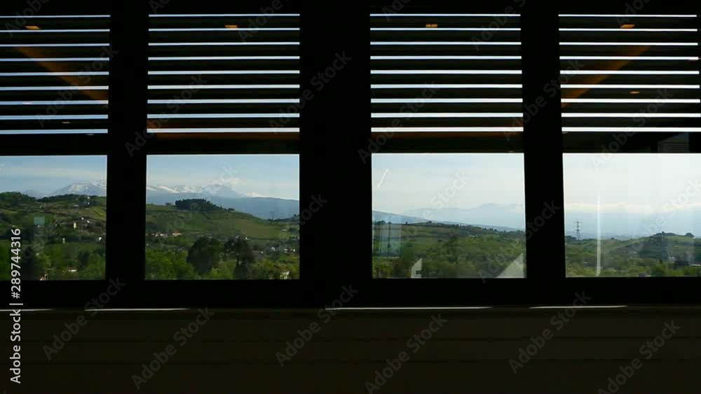 Rolling shutter of a window closing on the landscape. Countryside, hills. Rolling shutter of a window closing on the landscape. Countryside, hills.