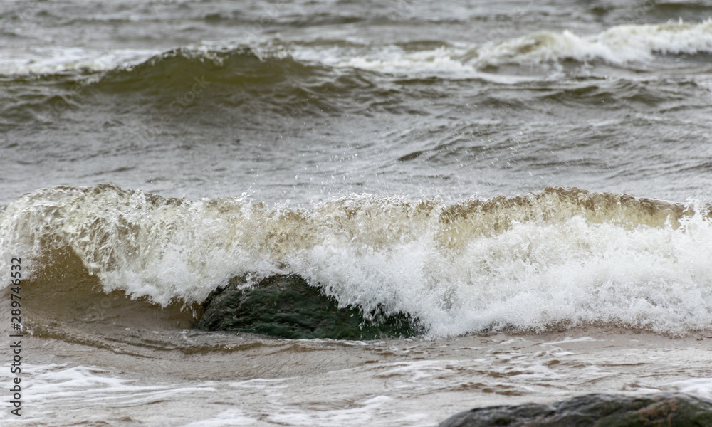 Big breaking sea wave on a sandy beach on the Baltic Sea Big breaking sea wave on a sandy beach on the Baltic Sea