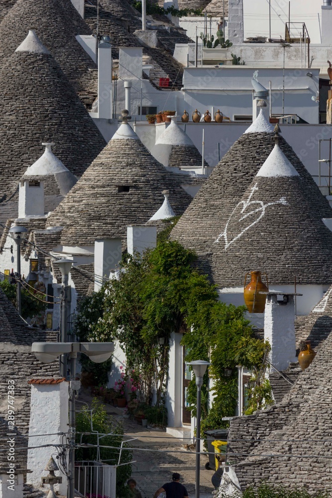 ALBEROBELLO, ITALY - AUGUST 28 2017: view from the top of traditional roofs in the town of Alberobello